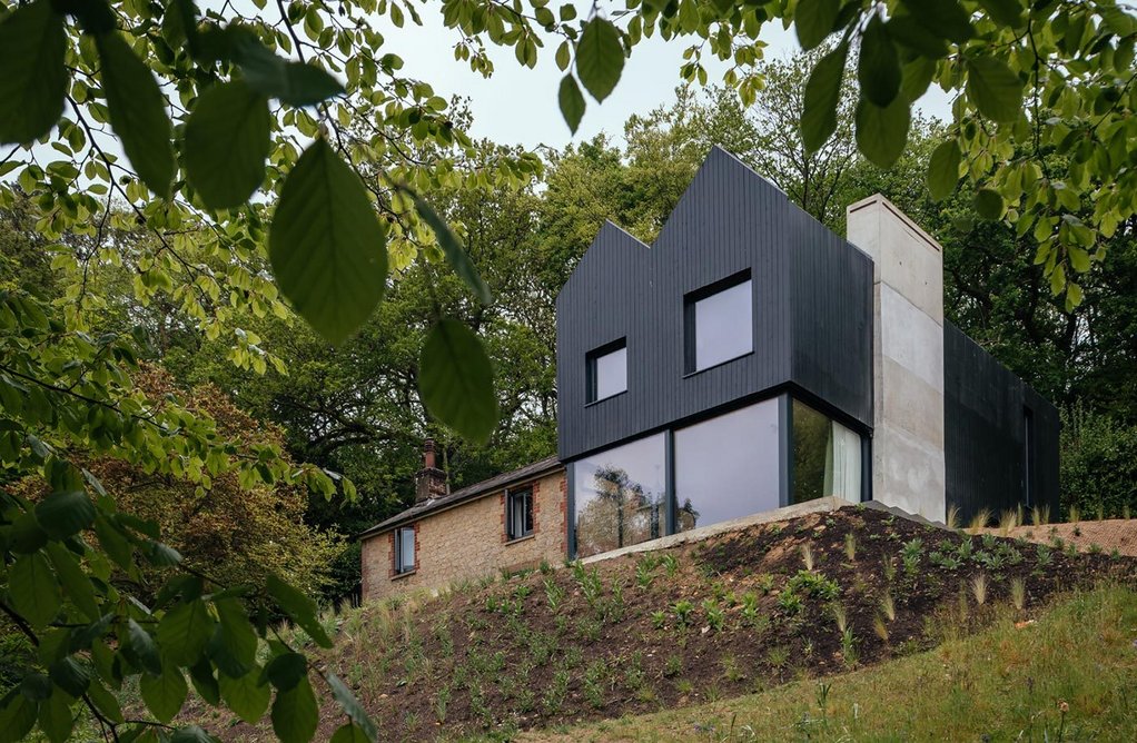 The concrete chimney is an important part of the structure of the extension.