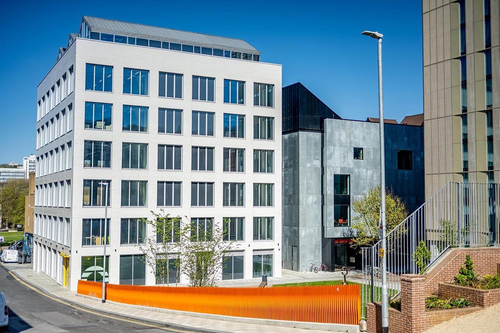 The folded roof of the office block alludes to the form of the market building that once occupied the site.