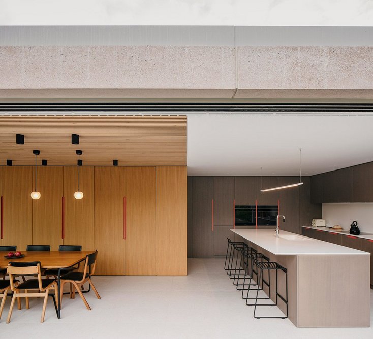 The kitchen slips back into the side extension beside the dining area.