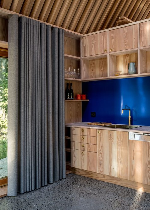 Looking out from the kitchen onto the landscape, through the Douglas fir interior with terrazzo floors.