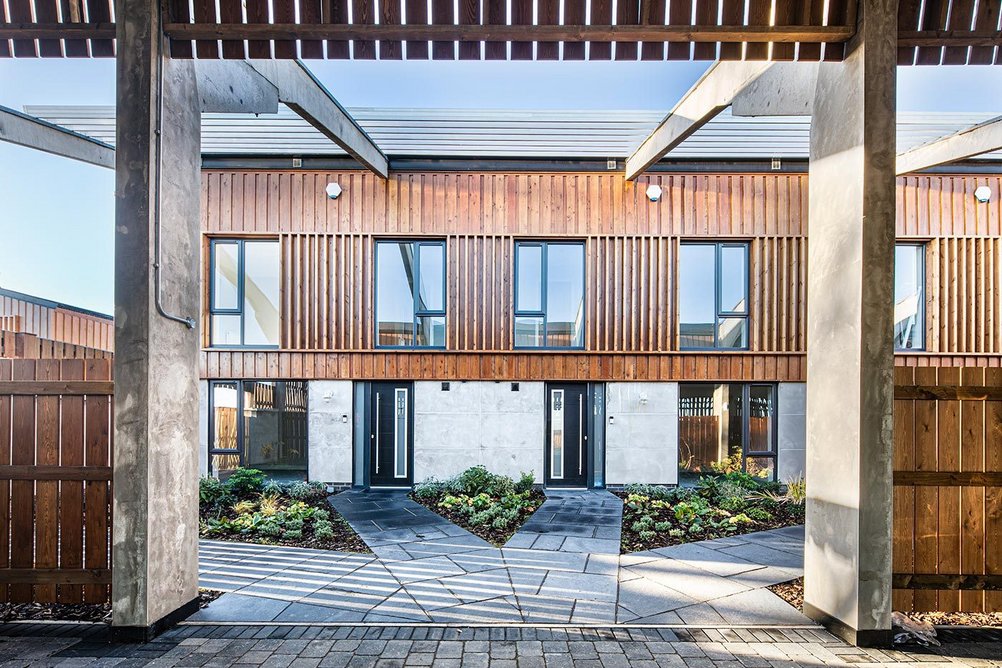 Zigzag pathways to the front doors, louvres between the concrete frame and planting all enliven the front gardens.