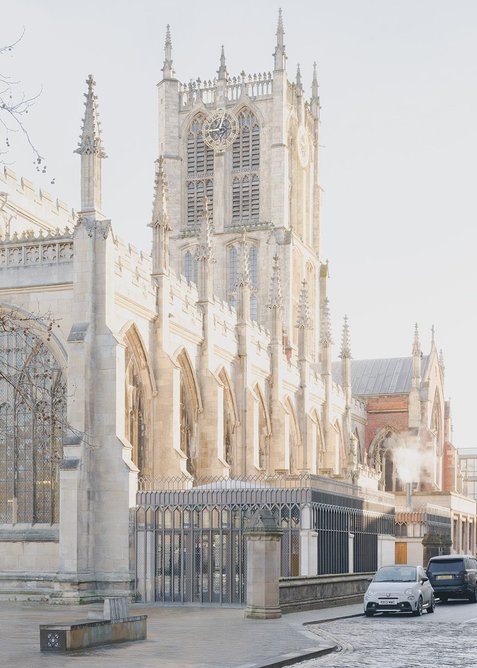 The Trinity Room sits humbly beside the church, its stone piers echoing the rhythm of the older building.