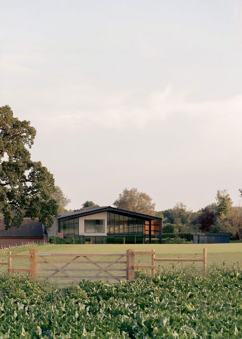 Seen from the back where the lightness of the front elevation recedes but the facade becomes more open and transparent.