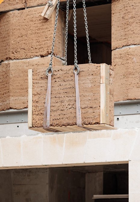 Blocks were formed in individual moulds, with earth rammed pneumatically and dried for three months before transportation from Lyon to Paris. The facade was then installed at a rate of 12-15m2 per day.