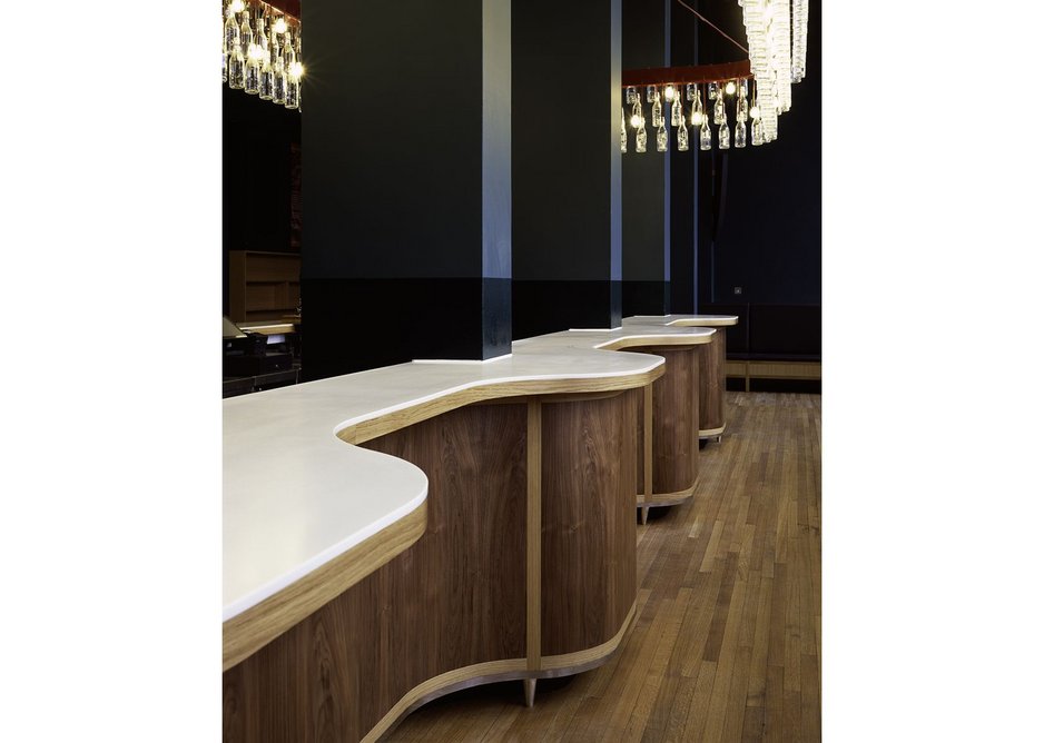 The bar's corian and timber curve around the columns.