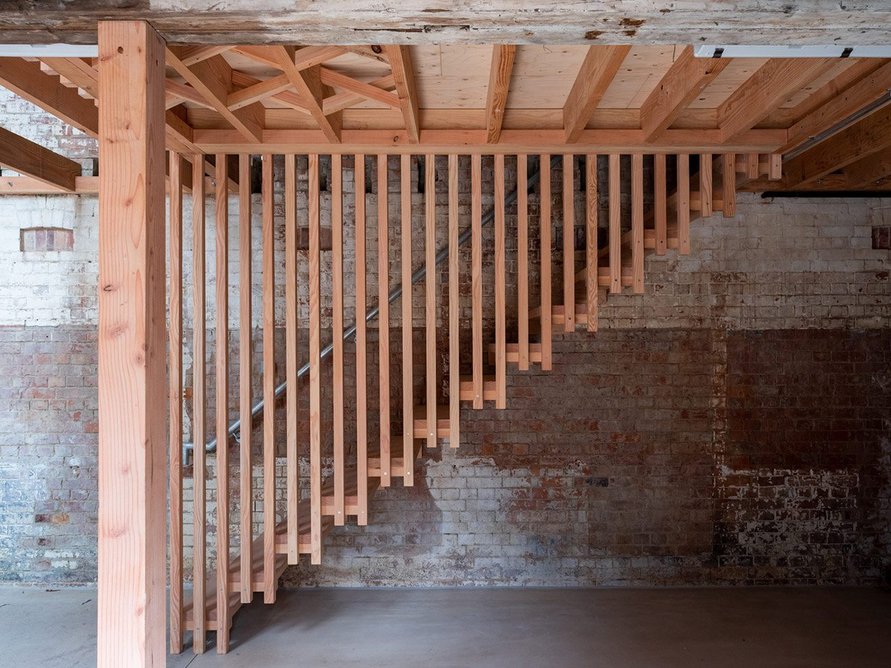 A stair leads to the first-floor site manager's office above a workshop in the southern farmyard.