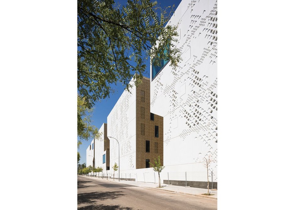 The patios of the east elevation  break up the solidity of the GRC facade.