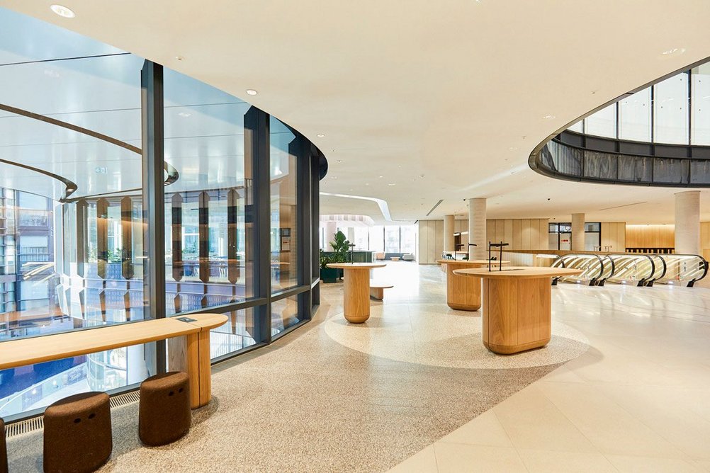 The second-floor reception area sits at the base of the atrium and overlooks the west entrance to Octagon Mall and Broadgate Circle through a curved glazed facade.