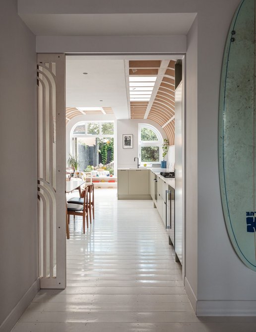 View into the extended kitchen, with rear social space beyond.