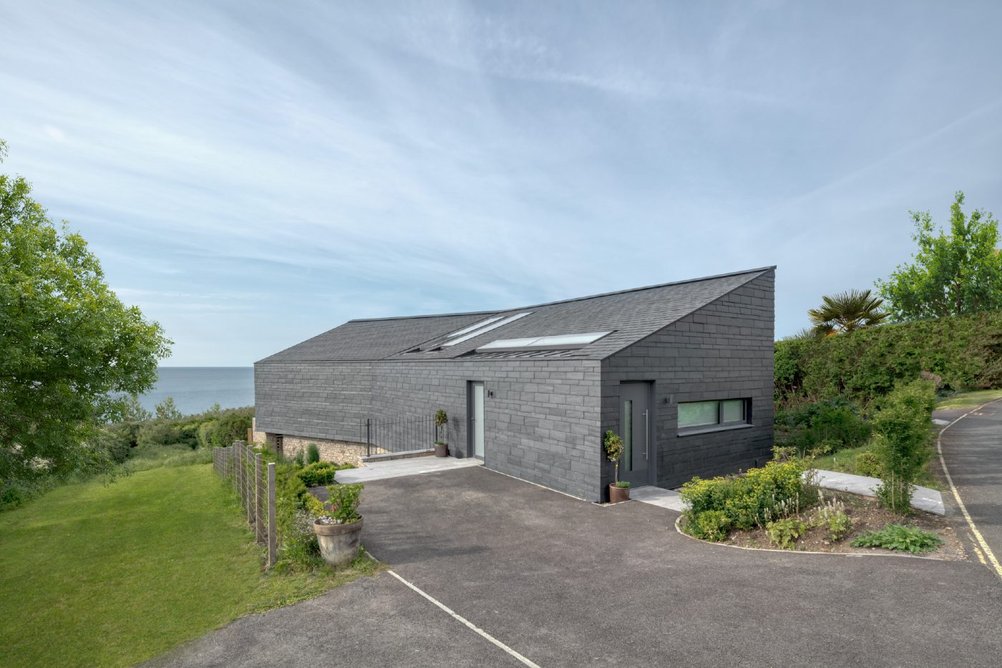 One of the semi-detached houses from the side, showing the lower ground floor built into the slope.