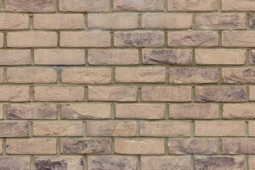 Buff-coloured brick - supplied by Taylor Maxwell - on the main building .