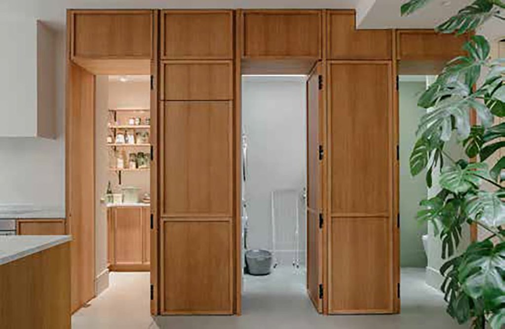 Three utility areas are concealed in a wall of hidden doors and storage.