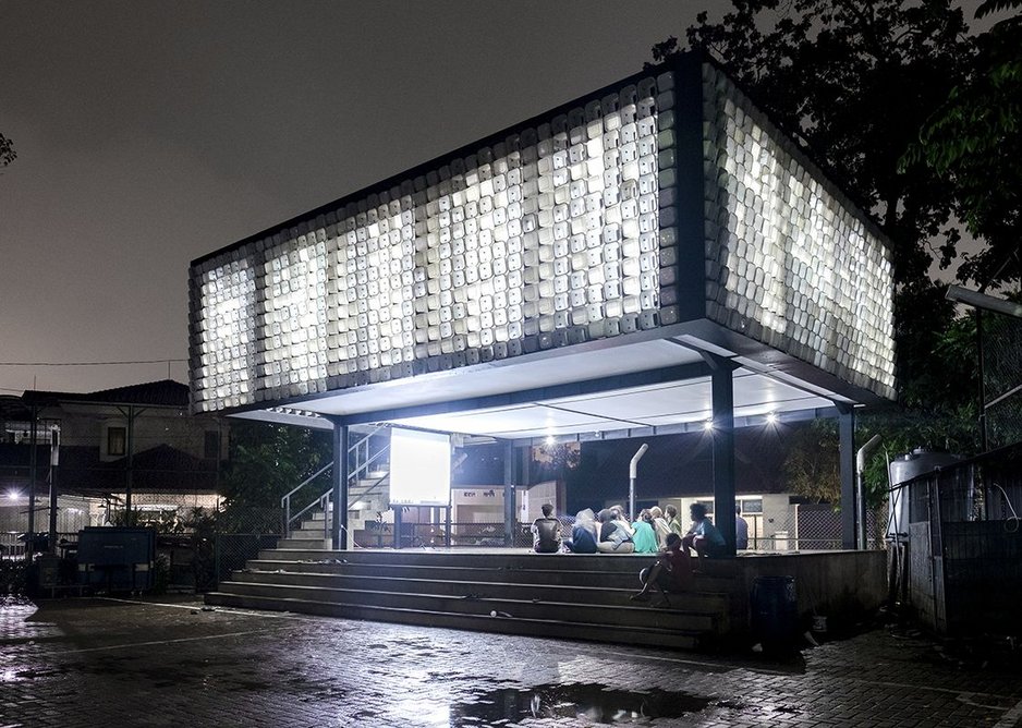Microlibrary at Taman Biman, Indonesia, designed by SHAU Indonesia using a facade of plastic ice cream buckets inserted into metal frames.