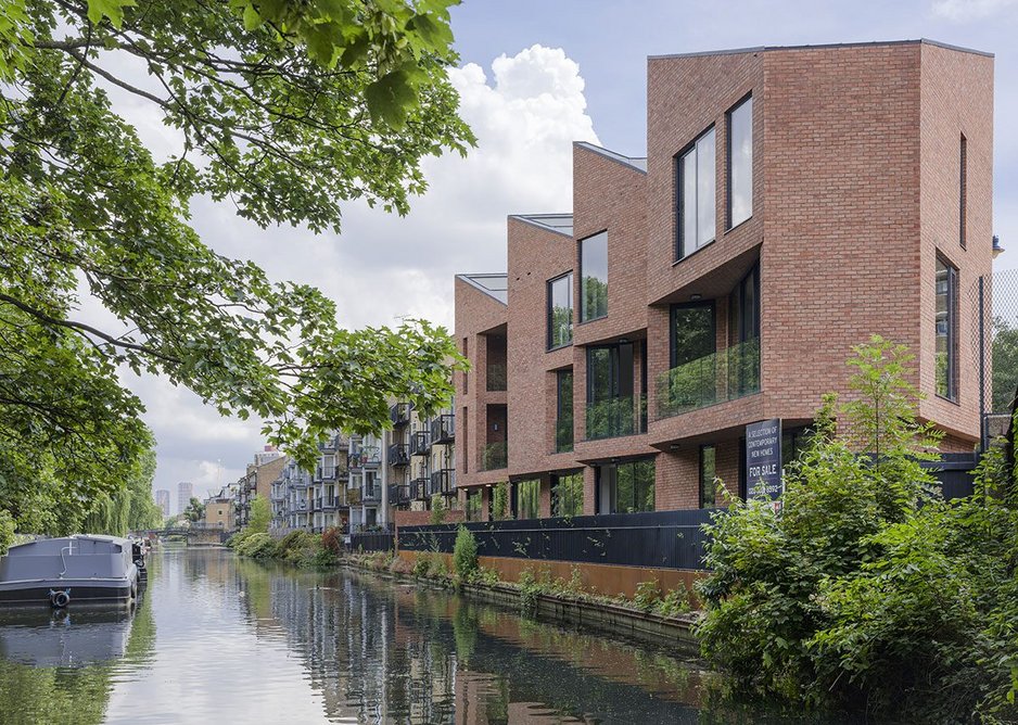 On the canalside the brick facade hovers over a glazed plinth giving onto a terrace.