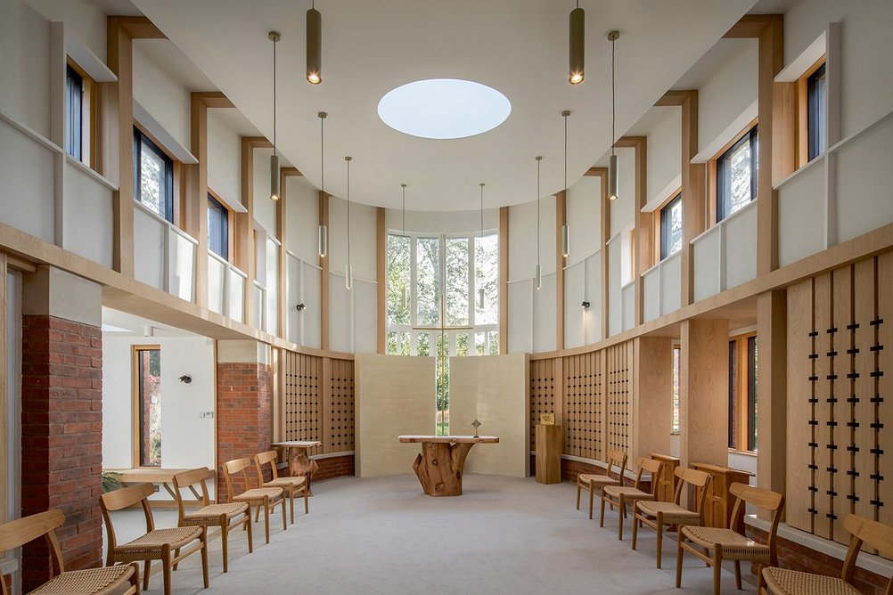 The chapel interior has acoustically absorbent perforated timber panelling.