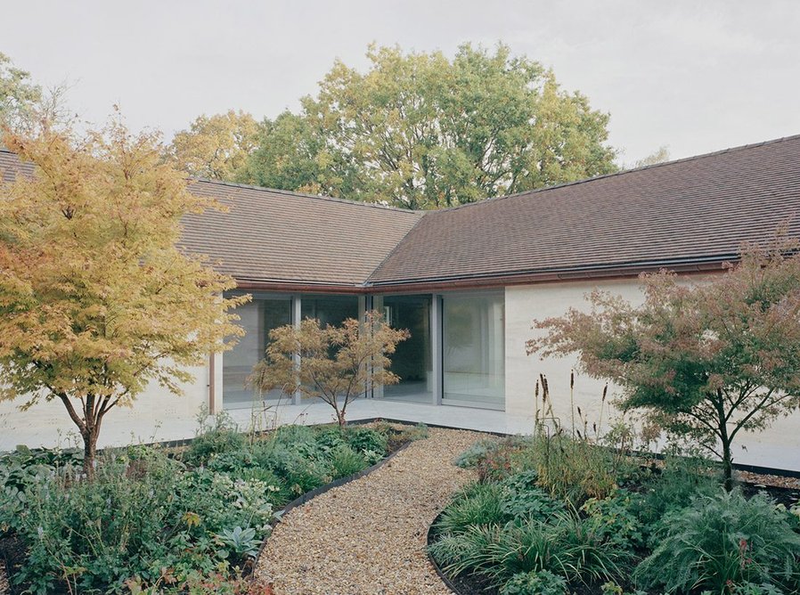 The courtyard opens fully, with large sliding glazing on all 4 corners.