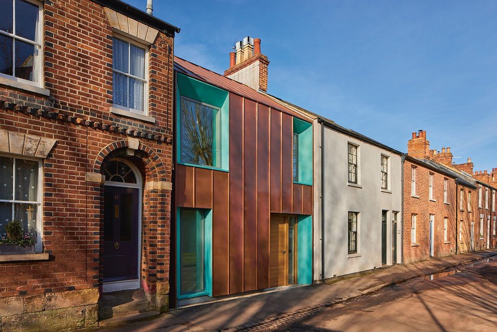 Clad in a copper rainscreen, the new yoga centre is clearly legible as a new intervention in the terrace.