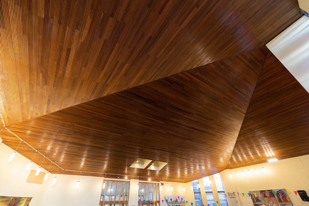 The church has an acoustic ceiling with perforated boarding over the main worship space.