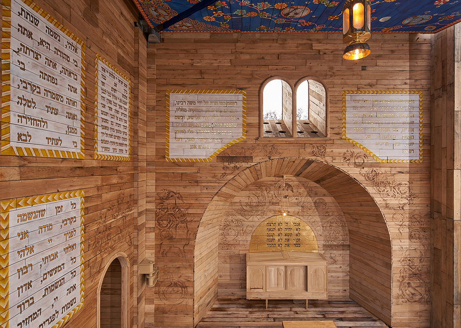 The walls of the Babyn Yar synagogue are decorated with prayers, blessings and symbols referencing the interiors of historic wooden synagogues in Ukraine.