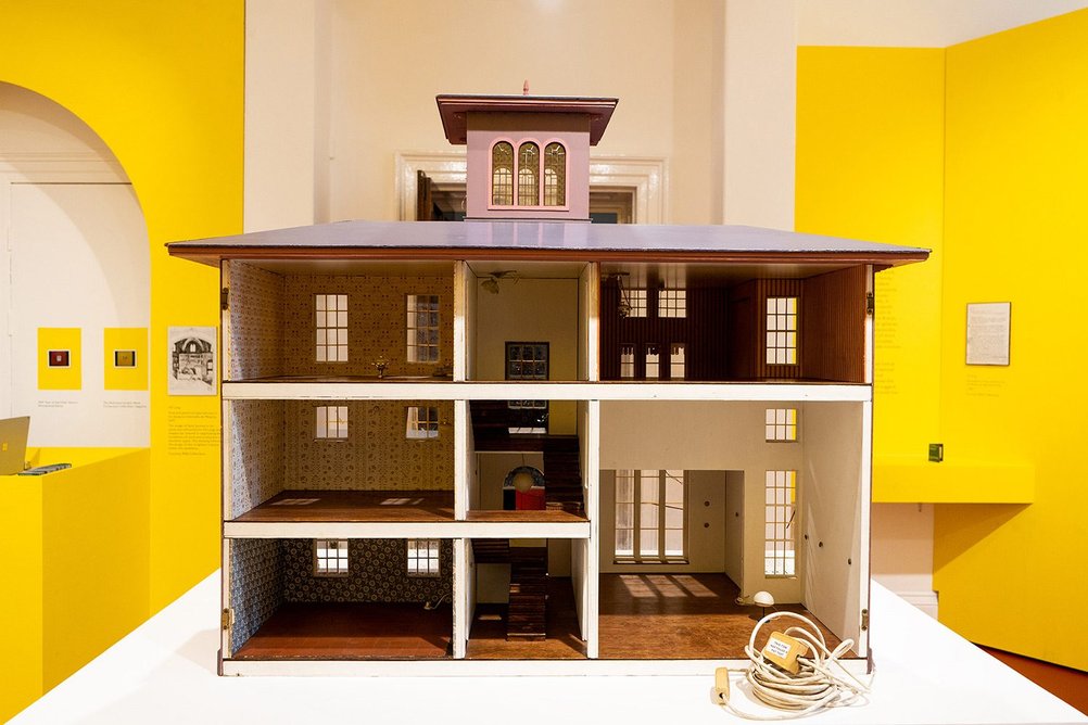 Installation view of Portraits of Practice: The Life and Work of MJ Long. The dolls house was bought at auction by exhibition curator Elena Palacios Carral.