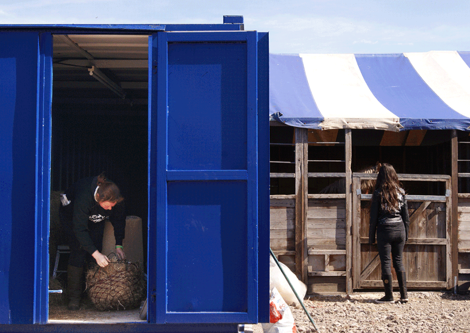 Outside are second-hand stables and an office in a shipping container.