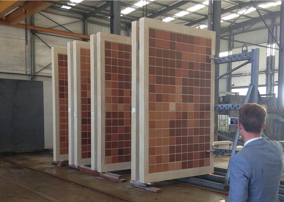 Concrete panels with elements of the L-system design overlaid in terracotta tiles.