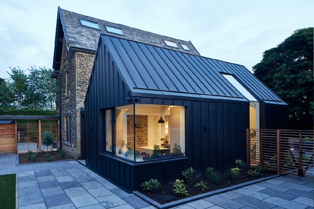 Schüco corner and architectural glazing opens up the zinc-clad extension.