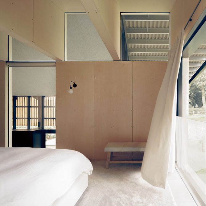 The plywood interior of the master bedroom above the pool – the screws that attach the panels are deliberately big and black to look like rivets or stitches.