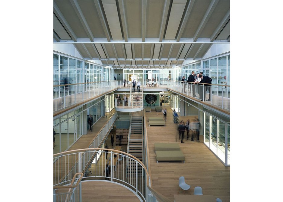 Circulation spaces around the atrium are broad enough to house informal working areas.