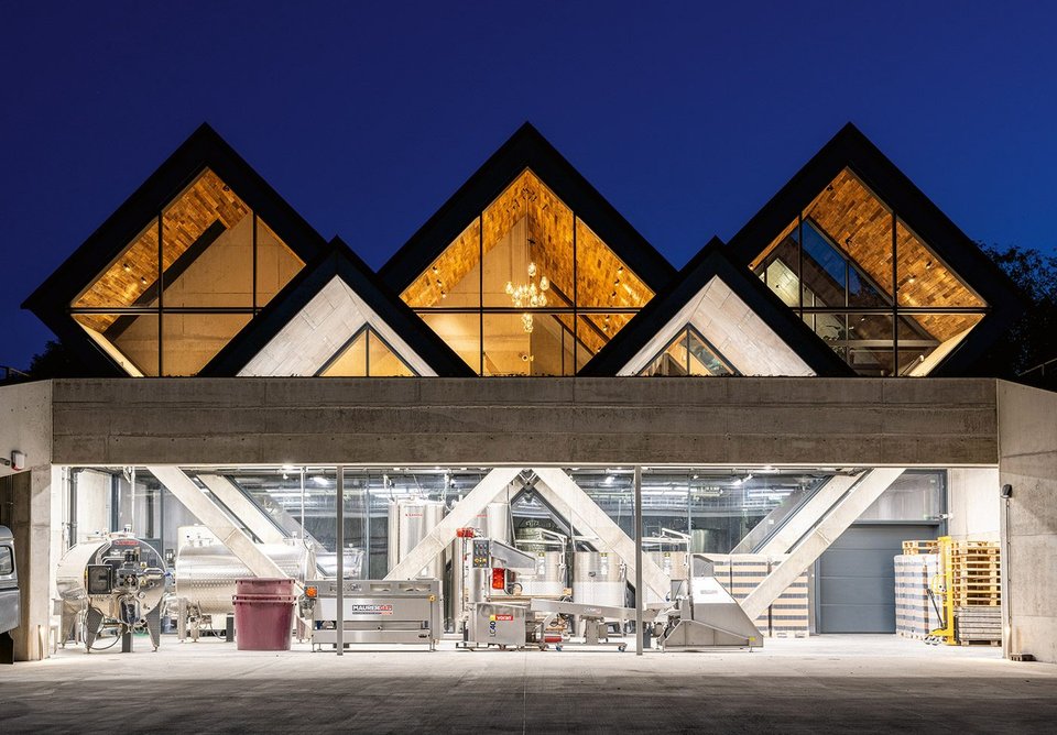 The west elevation reveals not just the hospitality spaces beneath the pitched roof, but the production facility in the basement.