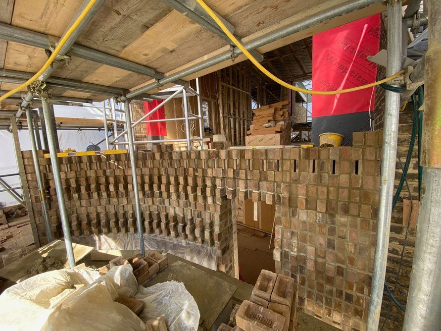House in Peckham under construction using bricks modified by Everything Now Design.