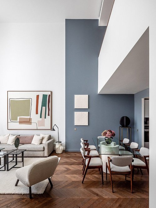 Double-height townhouse interior in darker palette.