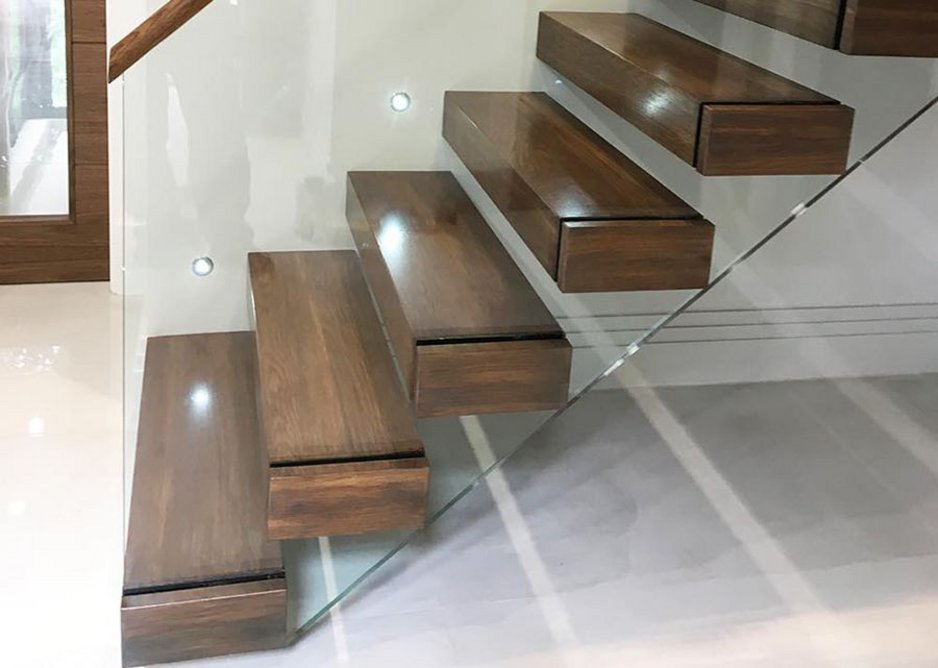 Canal Engineering's latest cantilever staircase with walnut treads and a glass balustrade.