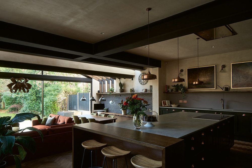There’s a subtle level change between the kitchen and living space, differentiating the zones.