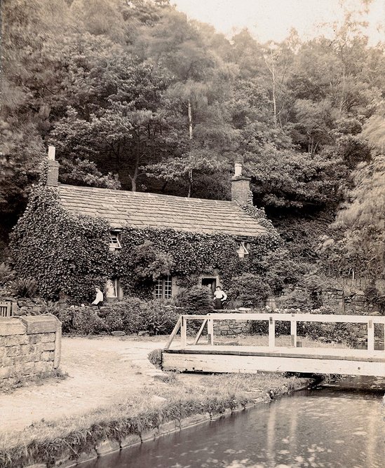 Historic photograph of Aqueduct Cottage, when it was occupied along a thriving waterway.