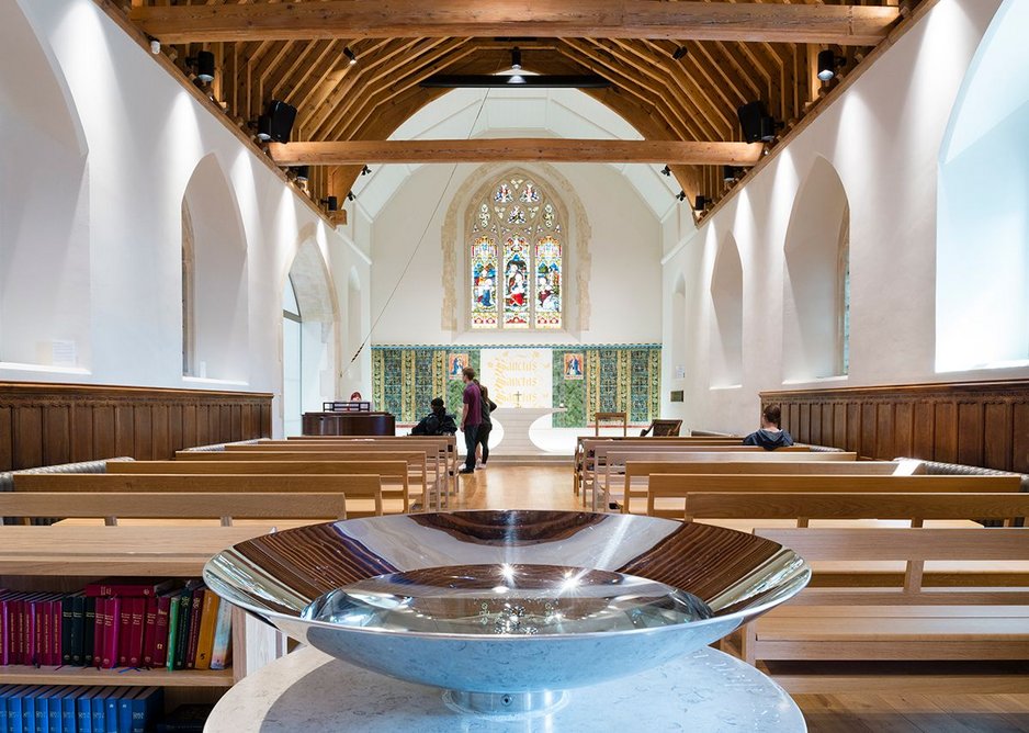 Double elliptical section of the altar at Winton Chapel as seen over the Purbeck limestone font.