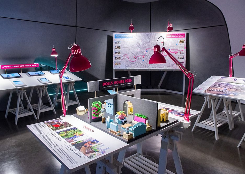 Exhibition installation view of London 2026:Recipes for Building a Food Capital at Roca London Gallery. The image shows a doll’s house for 2026 featuring sustainable food products such as in-house hydroponic planting and a food waste recycling unit.