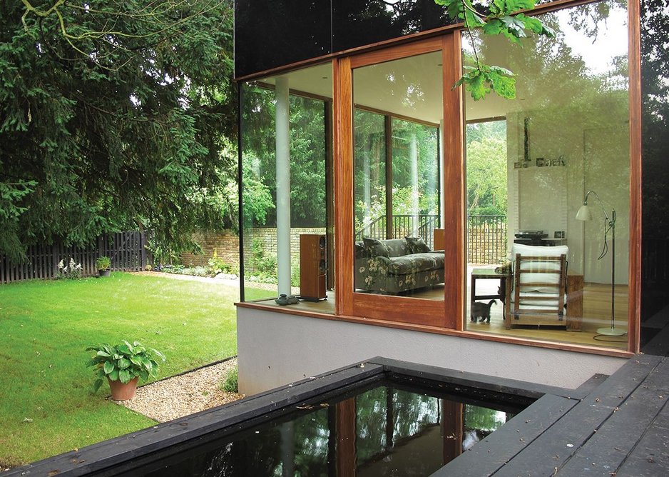 View from the raised decking to the garden, showing the intimacy of the home to the landscape. The machined look of the glass is counterpointed by the slightly rough edges of the timber cladding.