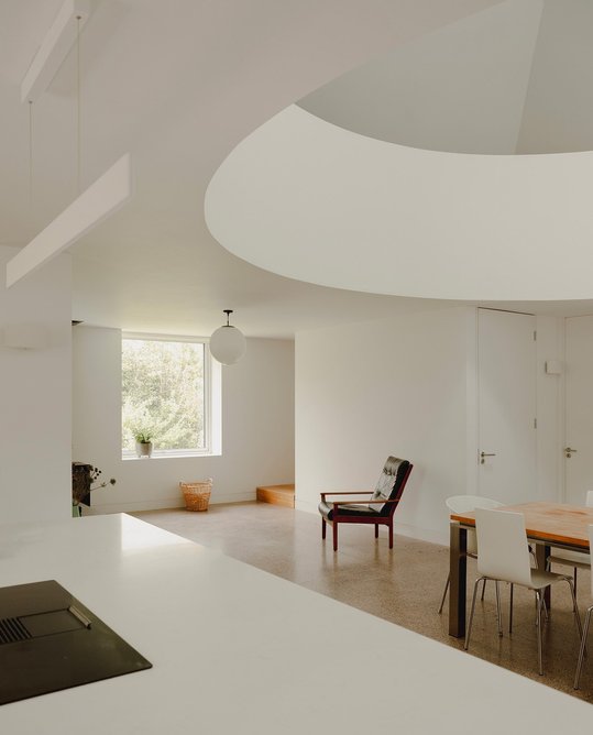 A living room, kitchen space and bedrooms are positioned in the ‘wings’ of the cruciform plan.