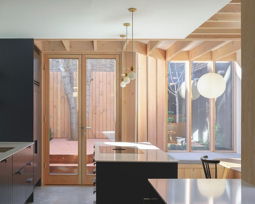 Douglas fir forms the exposed timber structure, large windows and doors.