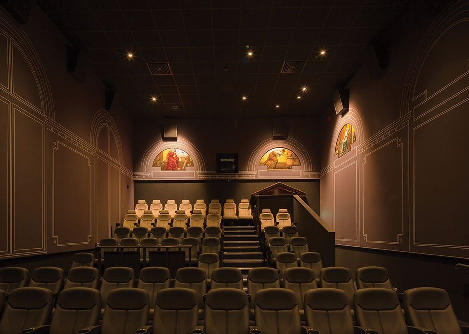 The old courtroom friezes have been retained and restored – the retractable screen rises to reveal the judges’ bench.