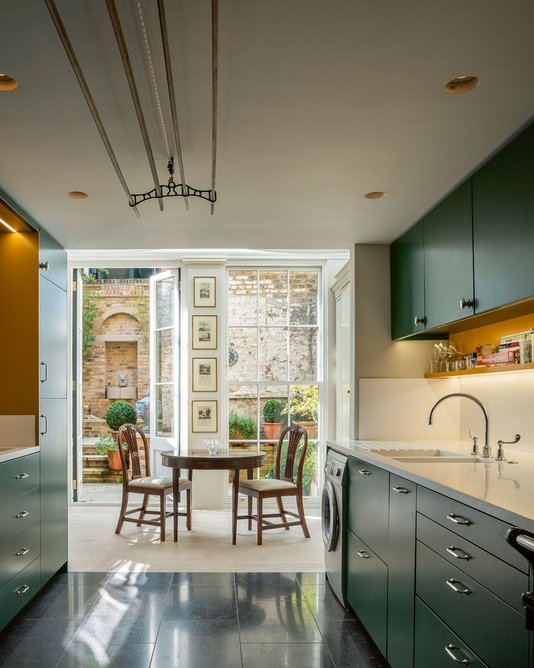 Looking through the newly relocated green and ochre kitchen, through the garden room to the fountain on the rear courtyard wall.