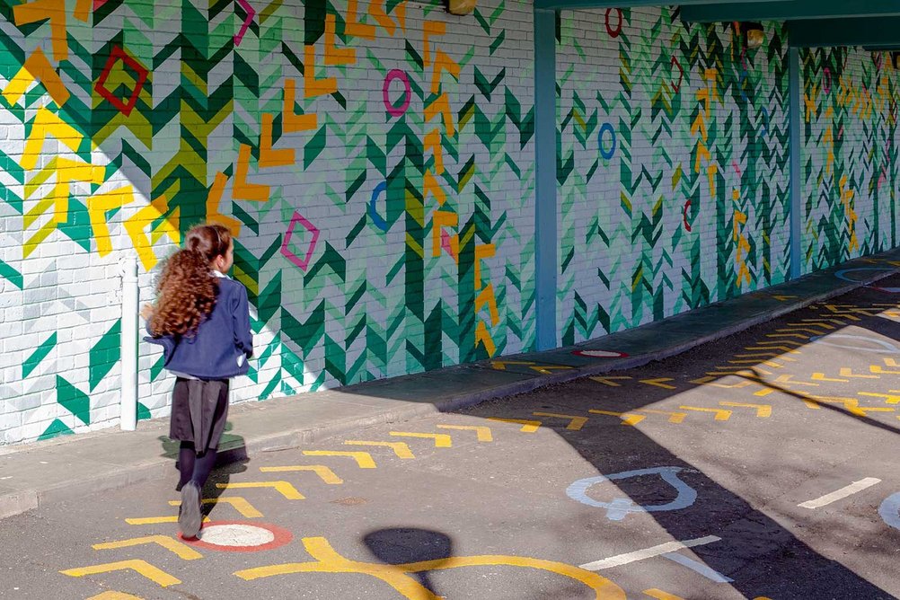 Bright wall and floor patterns enliven an underpass along Claridge Way.