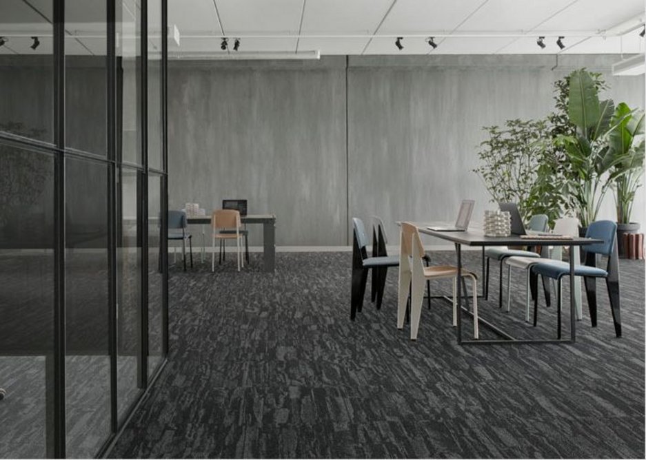 Shifting shades: A change in flooring colour helps distinguish meeting room from breakout space, while use of a single design maintains a cohesive look.