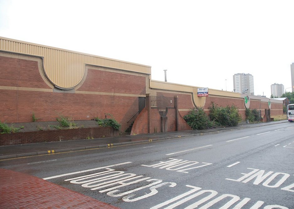 The brick walls and steel profile cladding of the original warehouse from Garscube Road.