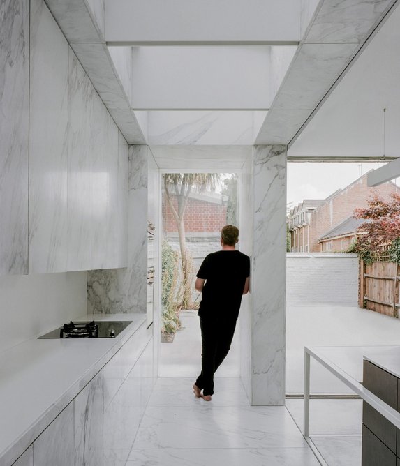 Inside the top-lit, marble-clad extension.