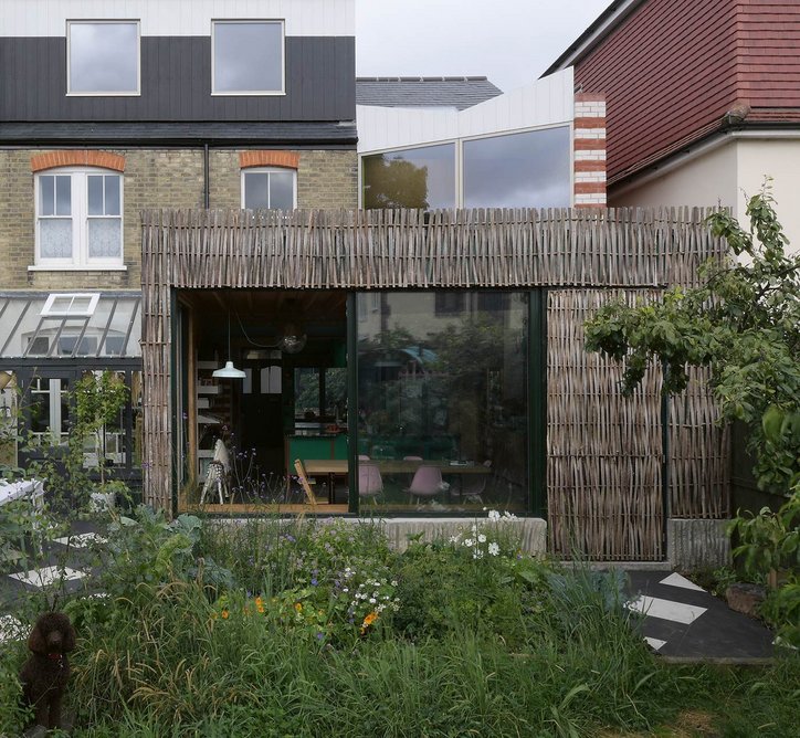 Woven, coppiced hazel clads the rear of the kitchen elevation