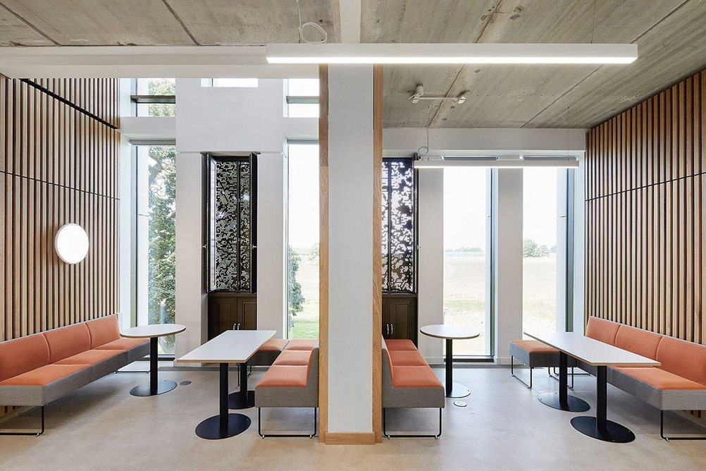 Timber-lined meeting areas align the top-lit principal circulation route.