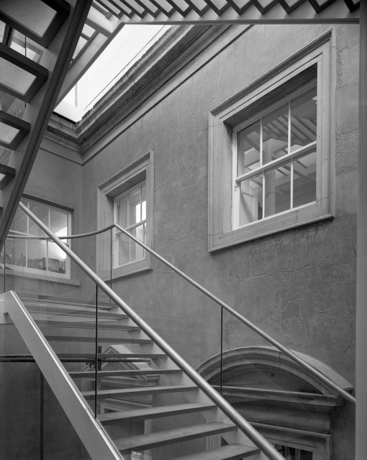Foster + Partners’ new staircase reclaims the space between two buildings at the Royal Academy of Arts. Burlington House (pictured) was designed by Samuel Ware in 1815.