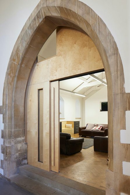 Pleasingly simple partition and sliding door to meeting and Sunday school space.